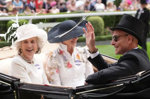 PA Media Actor Stanley Tucci looking up at something at Royal Ascot. He is wearing sunglasses and is wearing a suit.