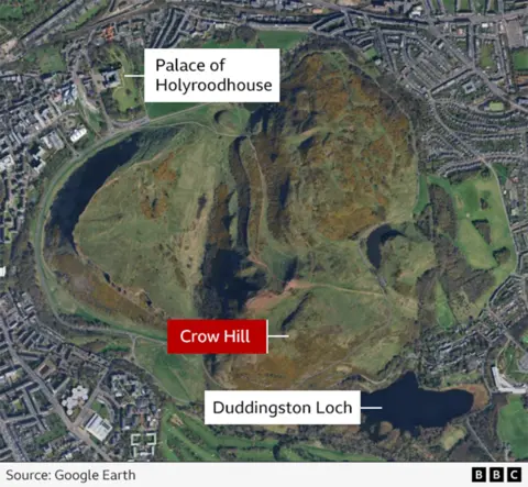 A map from above which shows a hill surrounded by buildings. At the top of the picture, a tag which reads Palace of Holyroodhouse points to a building near the edge of the hill. At the bottom of the hill, another tag reads Crow Hill. A final tag points to a loch at the bottom of the hill which reads Duddingston Loch.