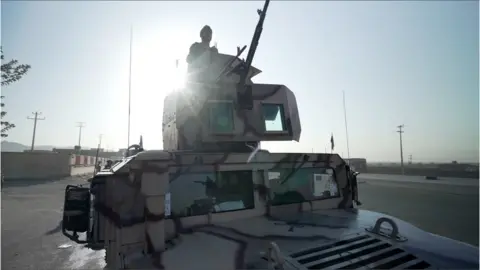 Image of an Afghan soldier in a tank