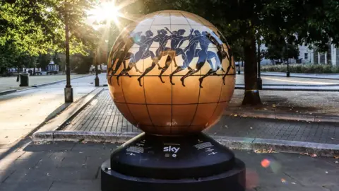 Paul Fears Gold globe with African tribal artwork