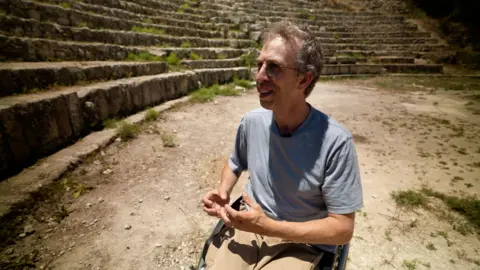 Israeli activist Alon Arad talks in the amphitheatre of the archaeological site of Sebastia, in the occupied West Bank