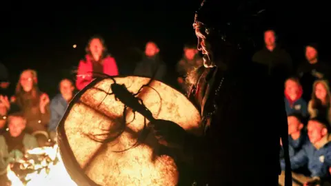 Artyom Geodakyan / Getty Images Siberian shaman with drum