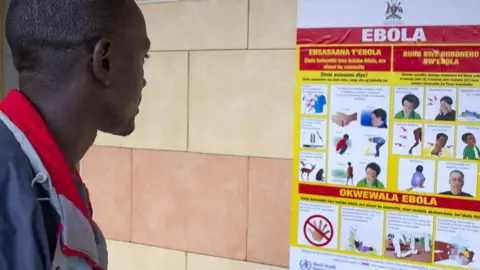 EPA Someone in Uganda looking at an Ebola poster