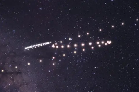 Tunç Tezel The paths of the planets Mars and Saturn shown swooping through the night sky