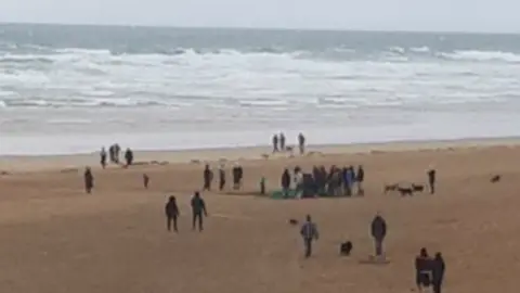 Katie Hicks ghost net being dragged up a beach