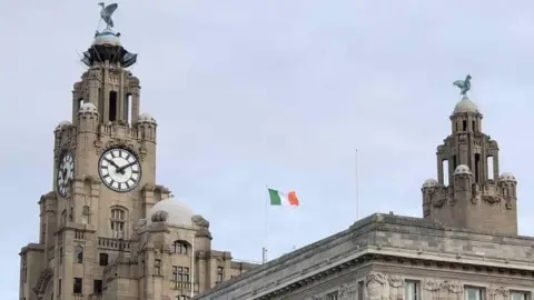 St Patrick's Day Parade Liverpool Liverpool Cunard Building flying Irish flag