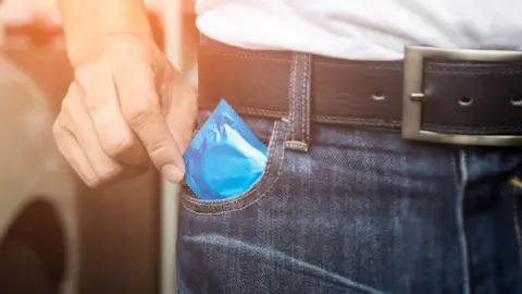 Getty Images Man with condom