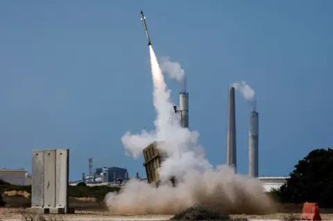 Reuters An Israeli Iron Dome missile defence system battery fires an interceptor missile after a rocket is launched from the Gaza Strip by Palestinian militants towards Israel on 7 August 2022