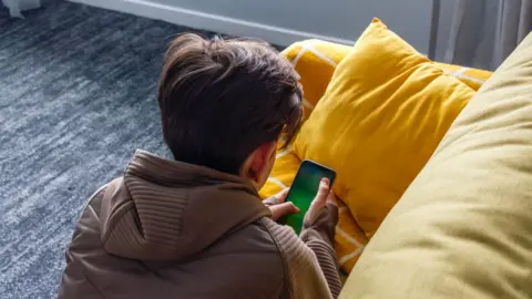 Getty Images Boy using mobile phone