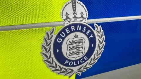 BBC Guernsey Police logo on the side of a police car