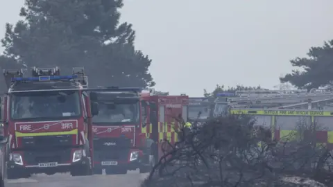 SFRS Fire engines on a road with more parked up. 