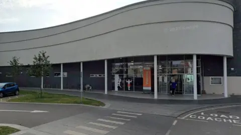 The exterior of Bridlington's sports centre. The atrium features a wave-like design, with a glass frontage 
