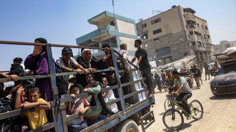 Palestinians in an open truck in Khan Younis