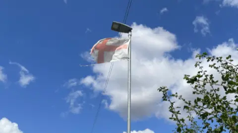 A tattered St George flag on a Coalville lamppost 