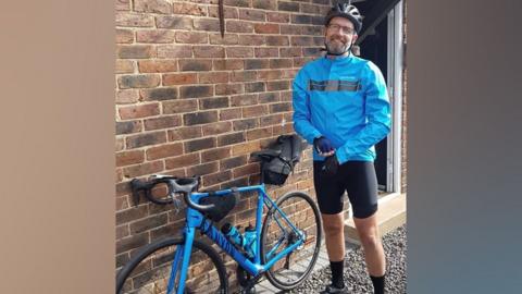 Nigel Woodhead in his cycle gear with a bike
