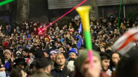 Reuters Supporters of Georgia's opposition parties hold a rally to protest against the new government's decision to suspend the European Union accession talks and refuse budgetary grants until 2028, in Tbilisi, Georgia, on 30 November  2024.