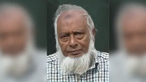 Supplied An older man looking at the camera in a checked shirt and a white beard.