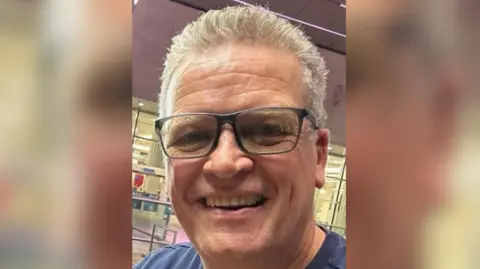 Bill Robinson A man with grey hair and glasses