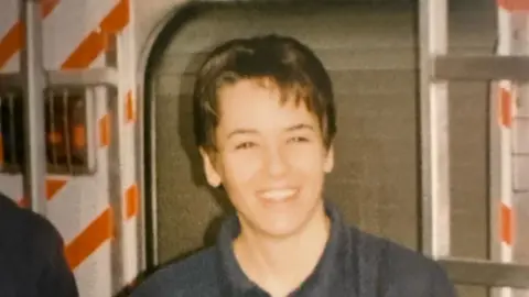 Suffolk County Council An old photo of Ms Hammond. She smiles at the camera. She has short brown hair and wears a blue T-shirt.