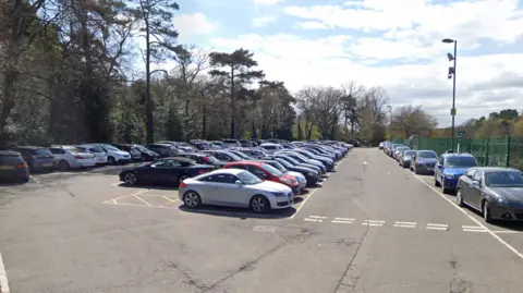 Google Maps Rows of cars parked in a car park on a sunny day