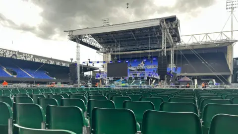 Dino Cabras Seats in the foreground at Portman Road, with a stage in the centre of the pitch, surrounded by the stands at the stadium