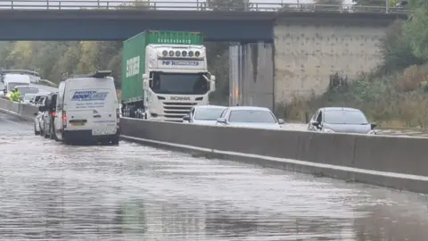 National Highways The A1 in County Durham. There is a lot of water with several vehicles on the road.