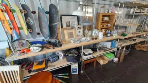 The inside of a Kernow Reuse Shop, with shelves full of second-hand items