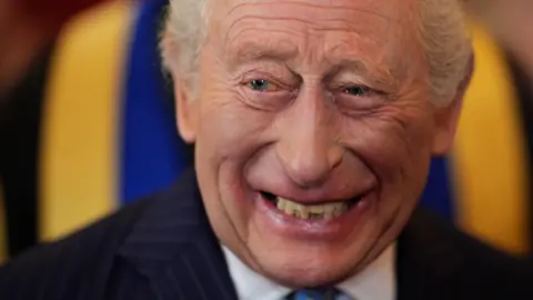 PA Media The King laughing.