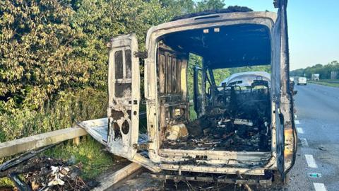 The burnt out van in a layby