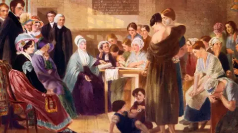 Getty Images A colorful drawing showing Elizabeth Fry sitting at a table in Newgate Prison in the early 19th century. She has a book in front of her. On the right sit female prisoners listening and talking, as well as two small children playing. To her left are four well-dressed women and at least three clergy in dark clothing. 