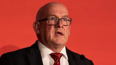 Chair Richard Collier-Keywood speaks on the stage at the WRU AGM