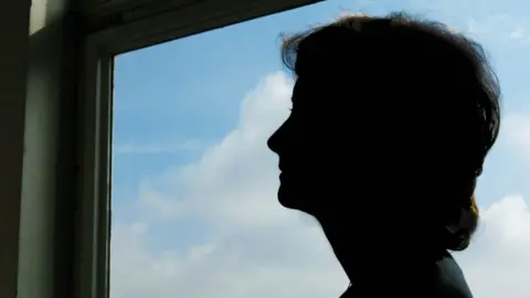 BBC Woman in profile against a window