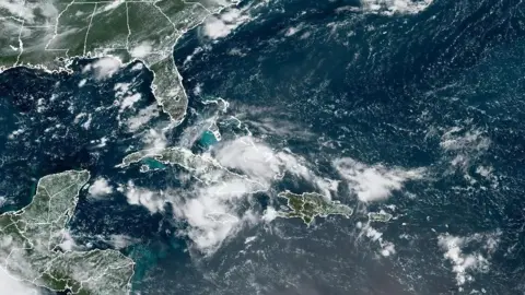 Satellite image from NOAA taken on 2 August shows clouds hovering over Cuba