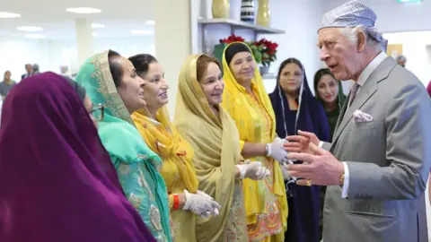 PA Media King Charles met with volunteers at a soup kitchen