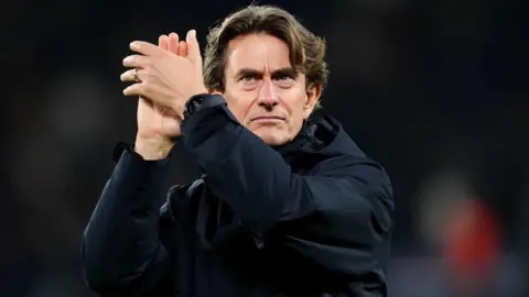 Head coach Thomas Frank applauds the Spurs fans after the Champions League defeat by Paris St-Germain.