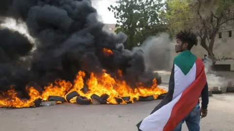 Getty Images Protesters block roads and burn tyres during a protest against economic crisis and high cost of living in Khartoum, Sudan on October 21, 2020.