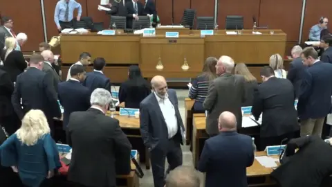 Oldham Council The councillors all leaving the chamber