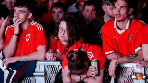 PA Media Dejected Wales fans at the 4TheFans Fan Park at The Tramshed, Cardiff, during a screening of the FIFA World Cup Group B match between Wales and England. Picture date: Tuesday November 29, 2022.