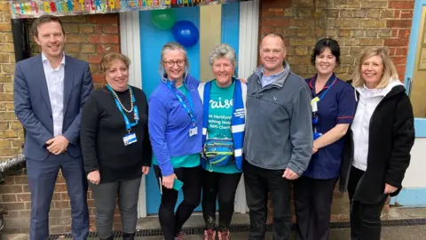 Justin Dealey/BBC Linda Pottinger smiling with her treatment team