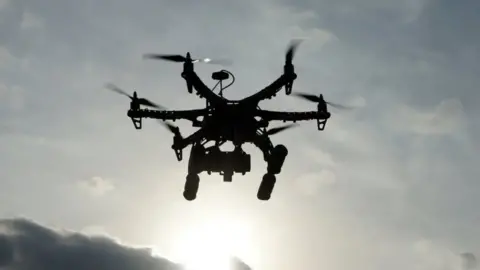 Getty Images The silhouette of a drone in the sky 