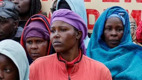 AFP Parents and members of the community gather outside the Nyeri county's Hillside Endarasha Academy in Nyeri county on September 6, 2024 after a fire broke out killing 17 children. 