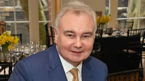 Getty Images A headshot of Eamonn Holmes wearing a suit