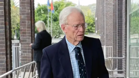 Neil Douglas Retired teacher Iain Wares pictured entering a courthouse in South Africa in 2023