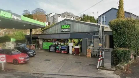 Google ASDA Express. Grey building with green logo and forecourt