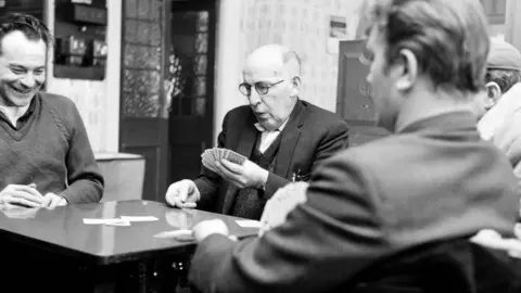 Mirrorpix/Getty Images Men playing cards at Buff's Working Men's Club, Middlesbrough, in March 1968