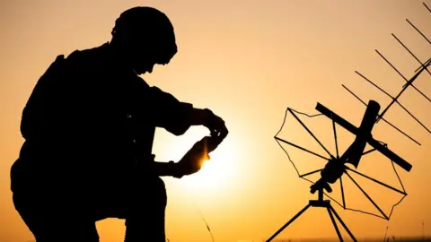 Dutch defence ministry The silhouette of a Dutch commando with the sun in the background