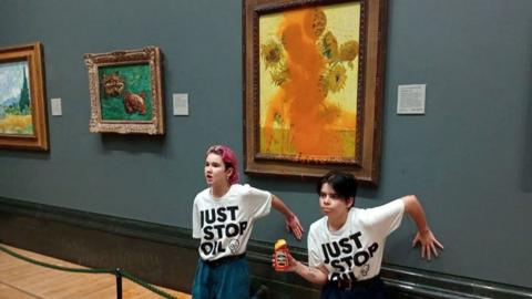 Activists of "Just Stop Oil" glue their hands to the wall after throwing soup at a van Gogh's painting "Sunflowers" at the National Gallery