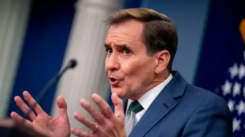 Getty Images White House national security spokesman John Kirby at the White House on 12 December. 