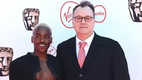Getty Images Ncuti Gatwa alongside Doctor Who showrunner Russell T. Davies on the day he was announced as the Doctor