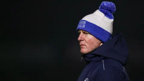 Getty Images Justin McNulty in the dark wearing a Laois hat and jacket